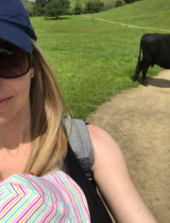 mom with baby, cow in background